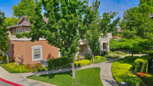 Exterior Aerial, Residential building, meticulous landscaping, lush vegetation, two story walk-up.