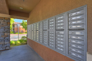 Exterior Covered cluster mailbox unit, landscaping leading to resident mailboxes.